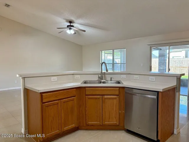 a view of a kitchen with a sink and cabinet