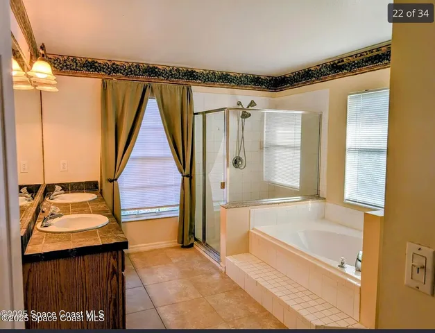 a bathroom with a tub sink and shower