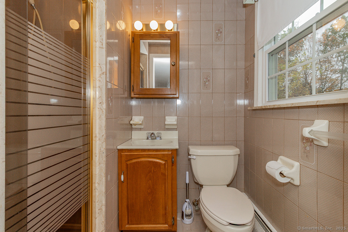 97 Longview Drive Berlin, CT 06037 - Photo 20 of 39 a bathroom with a toilet a sink and mirror