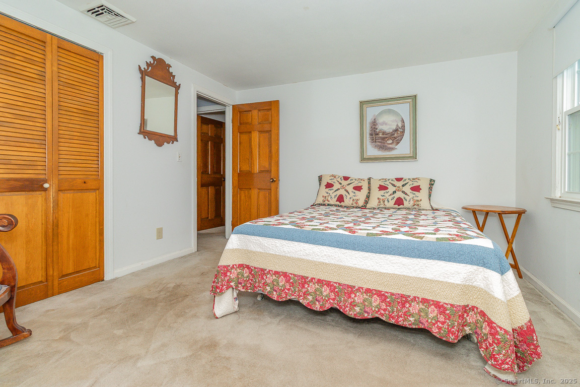 97 Longview Drive Berlin, CT 06037 - Photo 23 of 39 a bedroom with a bed and painting on the wall