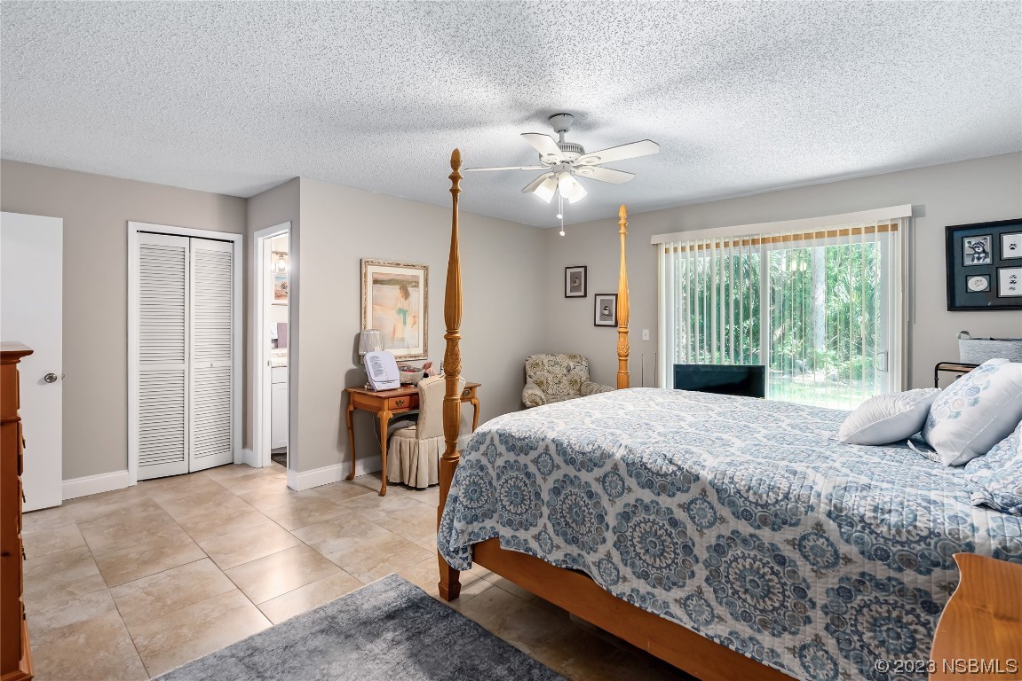 1109 Regent Street Edgewater, FL 32132 - Photo 11 of 27 a bedroom with a large bed and a chandelier