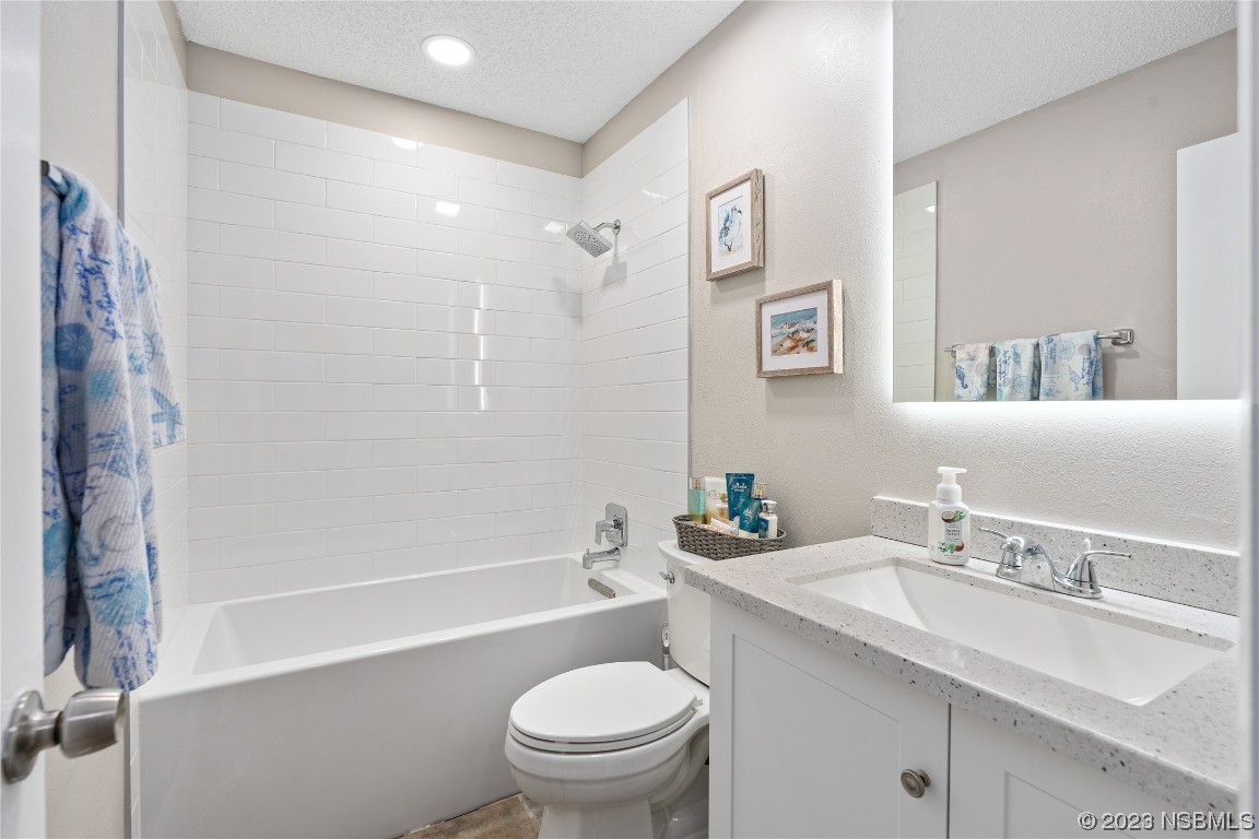 1109 Regent Street Edgewater, FL 32132 - Photo 16 of 27 a bathroom with a sink a toilet and a large mirror