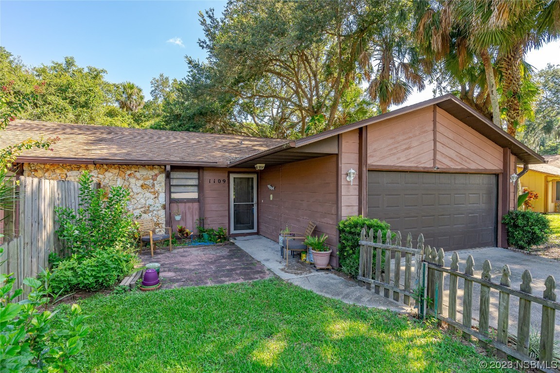 1109 Regent Street Edgewater, FL 32132 - Photo 19 of 27 a view of a house with a yard and plants