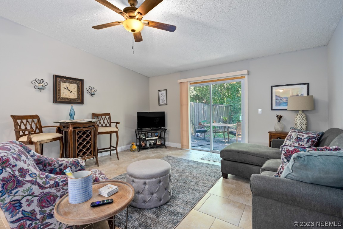 1109 Regent Street Edgewater, FL 32132 - Photo 3 of 27 a living room with furniture a flat screen tv and a large window
