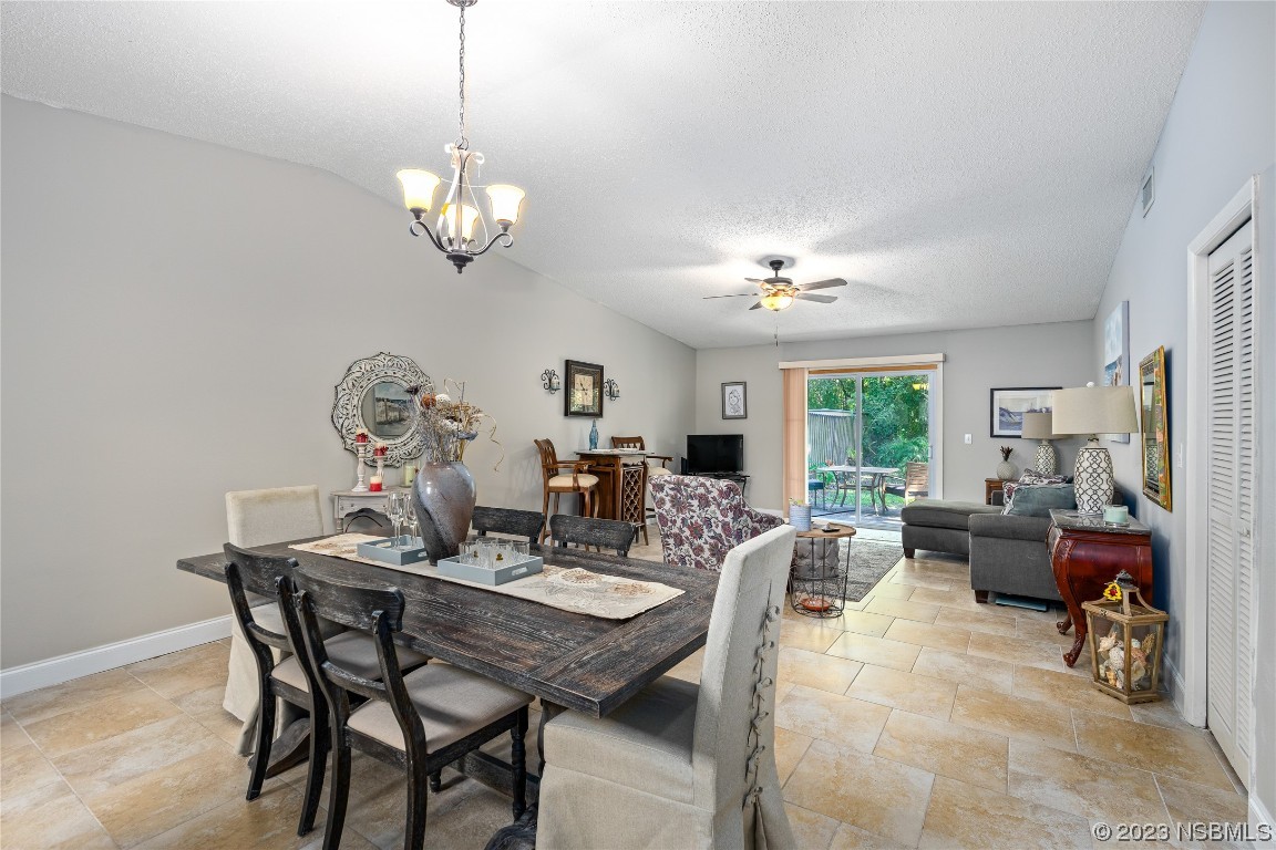 1109 Regent Street Edgewater, FL 32132 - Photo 5 of 27 a view of a dining room with furniture a chandelier and wooden floor