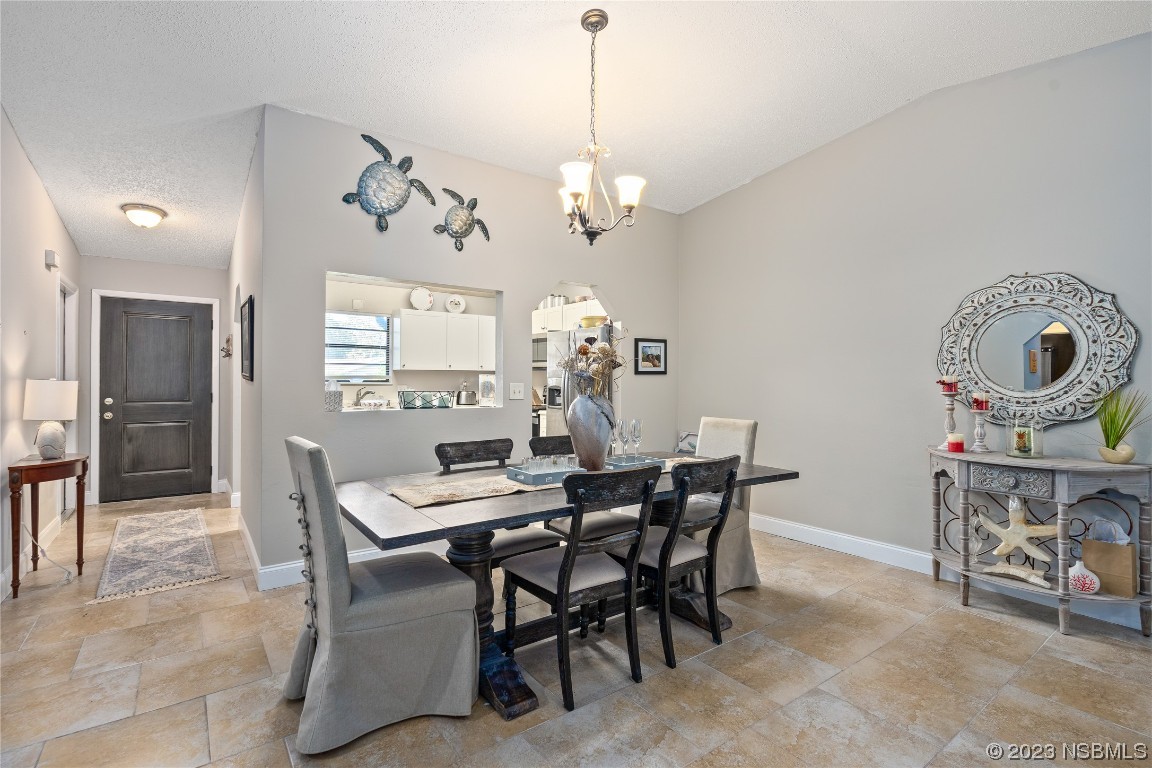 1109 Regent Street Edgewater, FL 32132 - Photo 6 of 27 a view of a dining room with furniture and chandelier