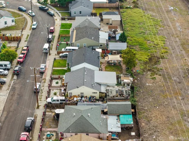 an aerial view of residential houses with outdoor space