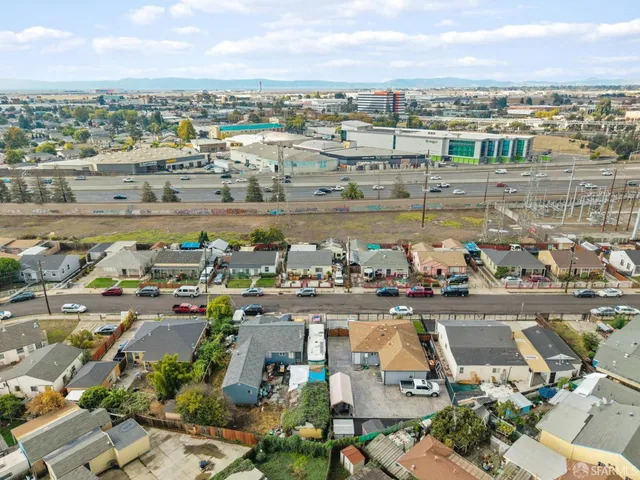 an aerial view of a city with lots of residential buildings ocean and houses
