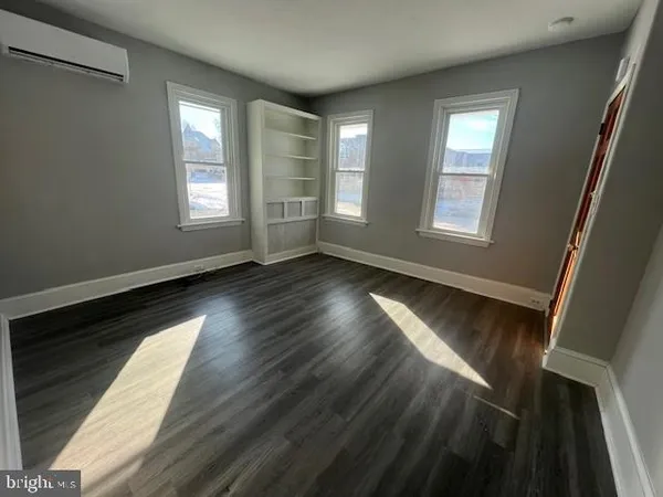 a view of wooden floor and windows in a room