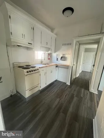 a kitchen with a stove a sink and a refrigerator
