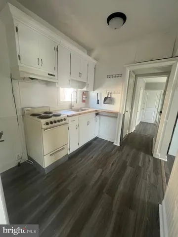 a kitchen with a stove a sink and a refrigerator