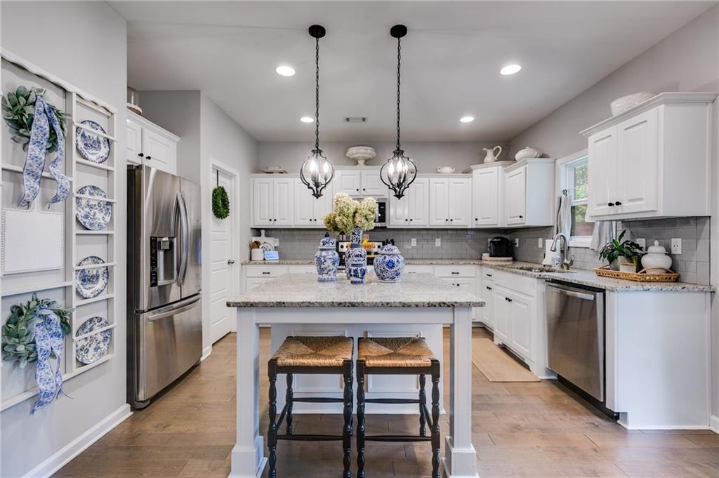 13 Westbrook Road Carrollton, GA 30116 - Photo 14 of 39 a kitchen with stainless steel appliances kitchen island granite countertop a refrigerator a sink and a stove