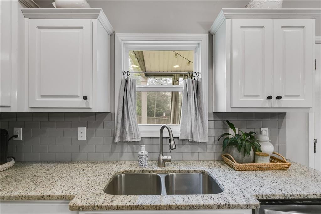 13 Westbrook Road Carrollton, GA 30116 - Photo 17 of 39 a kitchen with granite countertop a sink a stove and cabinets