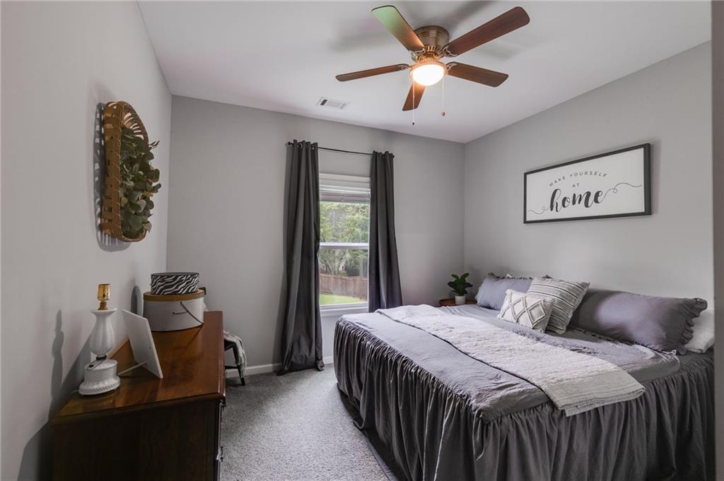 13 Westbrook Road Carrollton, GA 30116 - Photo 20 of 39 a bedroom with a bed and a chandelier