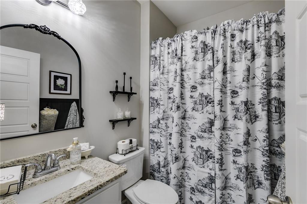 13 Westbrook Road Carrollton, GA 30116 - Photo 21 of 39 a bathroom with a granite countertop sink and a mirror