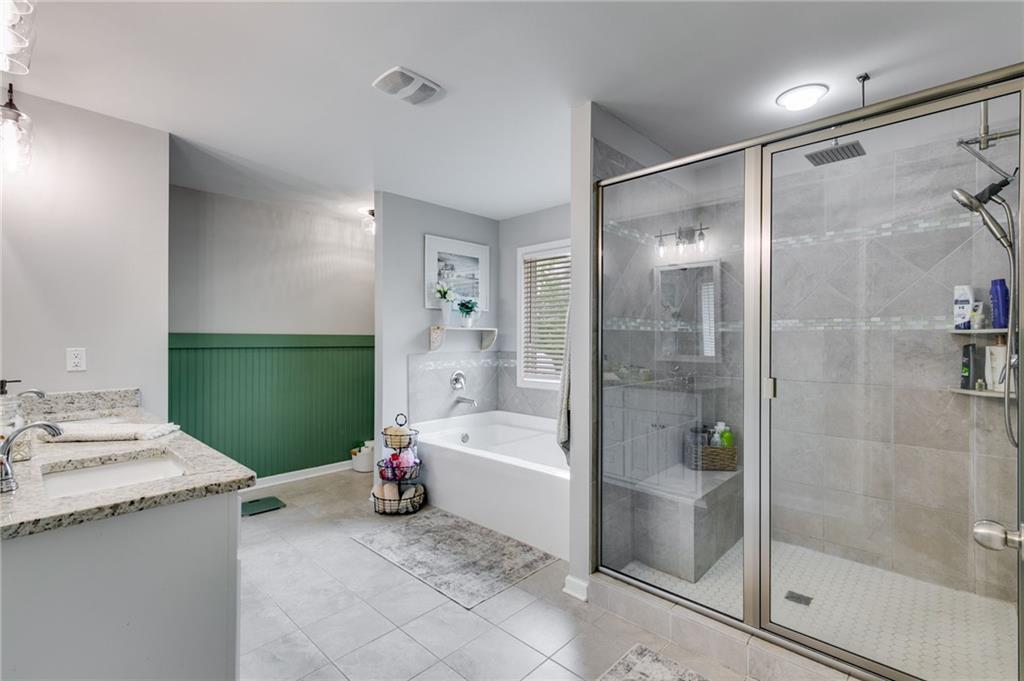 13 Westbrook Road Carrollton, GA 30116 - Photo 25 of 39 a bathroom with a granite countertop sink a mirror and a bathtub