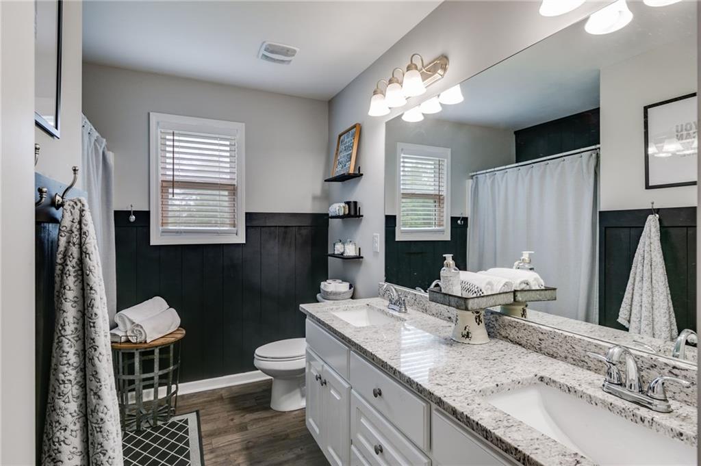 13 Westbrook Road Carrollton, GA 30116 - Photo 27 of 39 a bathroom with a granite countertop sink toilet and a mirror