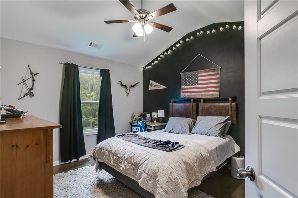 13 Westbrook Road Carrollton, GA 30116 - Photo 28 of 39 a bedroom with a bed and a chandelier