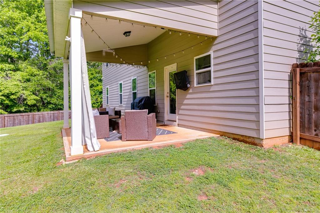 13 Westbrook Road Carrollton, GA 30116 - Photo 32 of 39 a view of a chair and table in back yard of the house