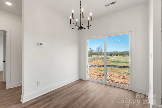 a view of a room with wooden floor cabinet and a window