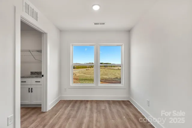 an empty room with windows and closet