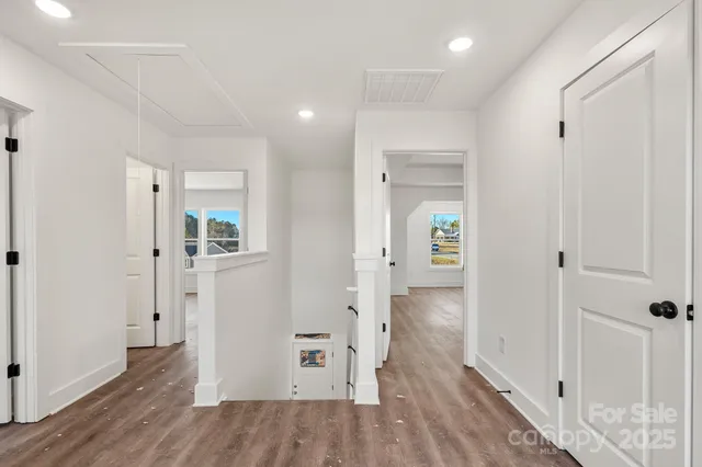 wooden floor in a hall with an entryway of a room