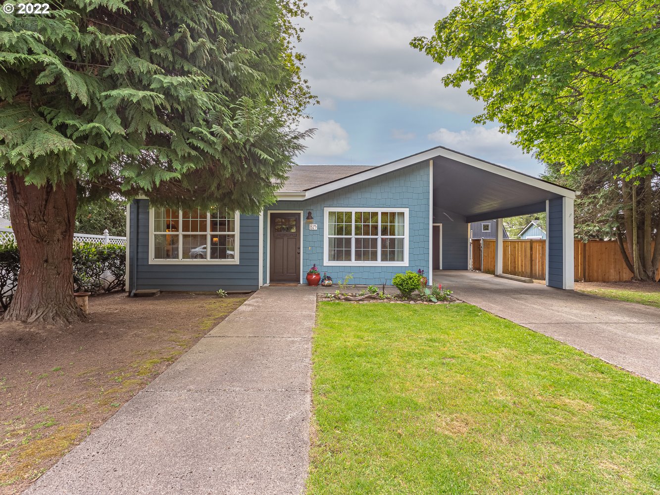 815 North Main Avenue Ridgefield, WA 98642 - Photo 1 of 32 a front view of a house with a garden