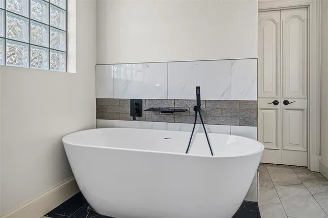 a white bath tub sitting in a bathroom