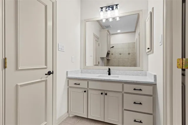 a bathroom with a granite countertop sink two mirror and a