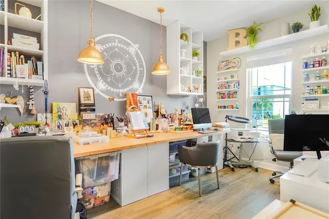 a view of a dining room with furniture a chandelier and wooden floor