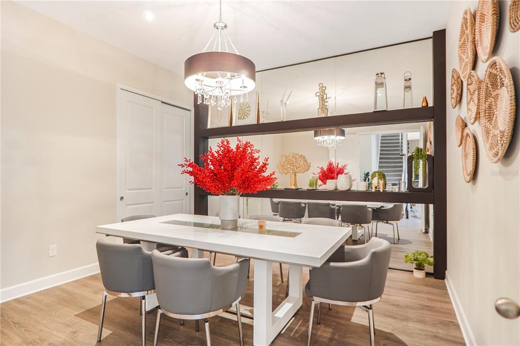 694 Brooks Field Drive Winter Garden, FL 34787 - Photo 17 of 74 a view of a dining room with furniture a chandelier and wooden floor