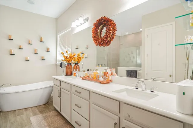 a large kitchen with stainless steel appliances kitchen island granite countertop a large cabinets a sink and a counter top space