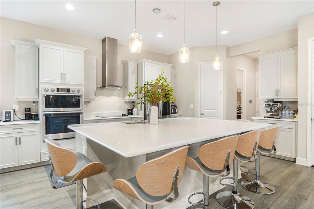 694 Brooks Field Drive Winter Garden, FL 34787 - Photo 29 of 74 a kitchen with kitchen island granite countertop a table and chairs in it