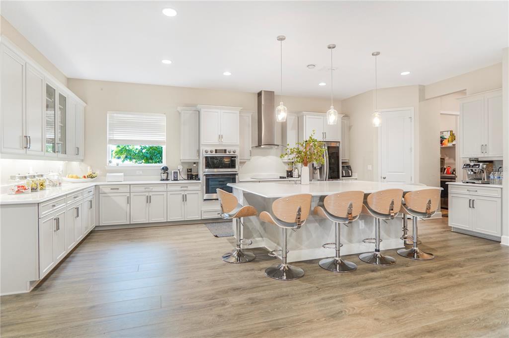 694 Brooks Field Drive Winter Garden, FL 34787 - Photo 30 of 74 a large kitchen with stainless steel appliances kitchen island granite countertop a large cabinets a sink and a counter top space