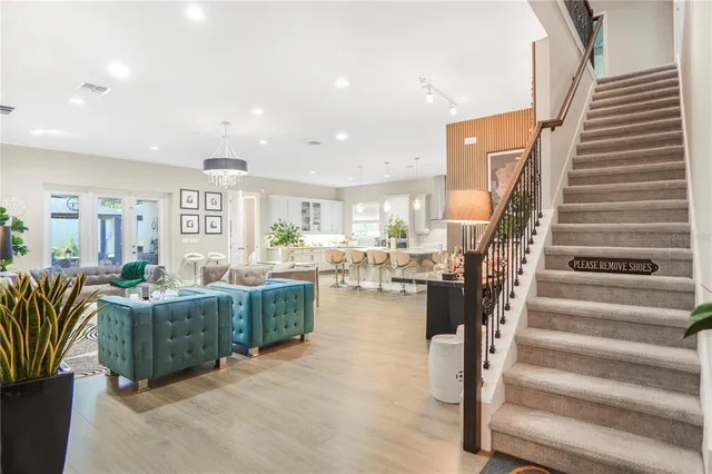 a living room with furniture and a dining table with wooden floor
