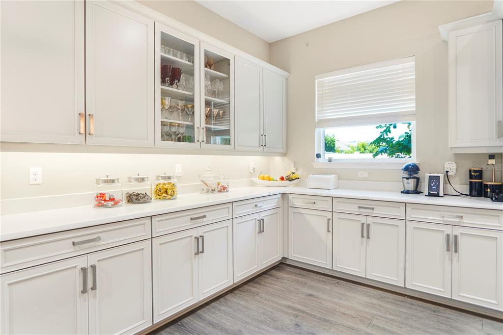 694 Brooks Field Drive Winter Garden, FL 34787 - Photo 32 of 74 a kitchen with granite countertop white cabinets and a sink