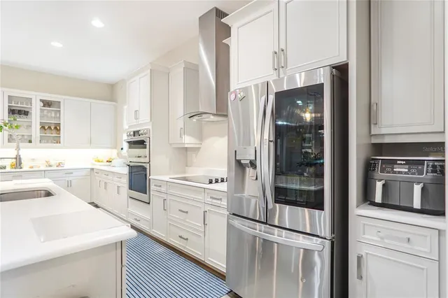 a living room with furniture a flat screen tv and a large window