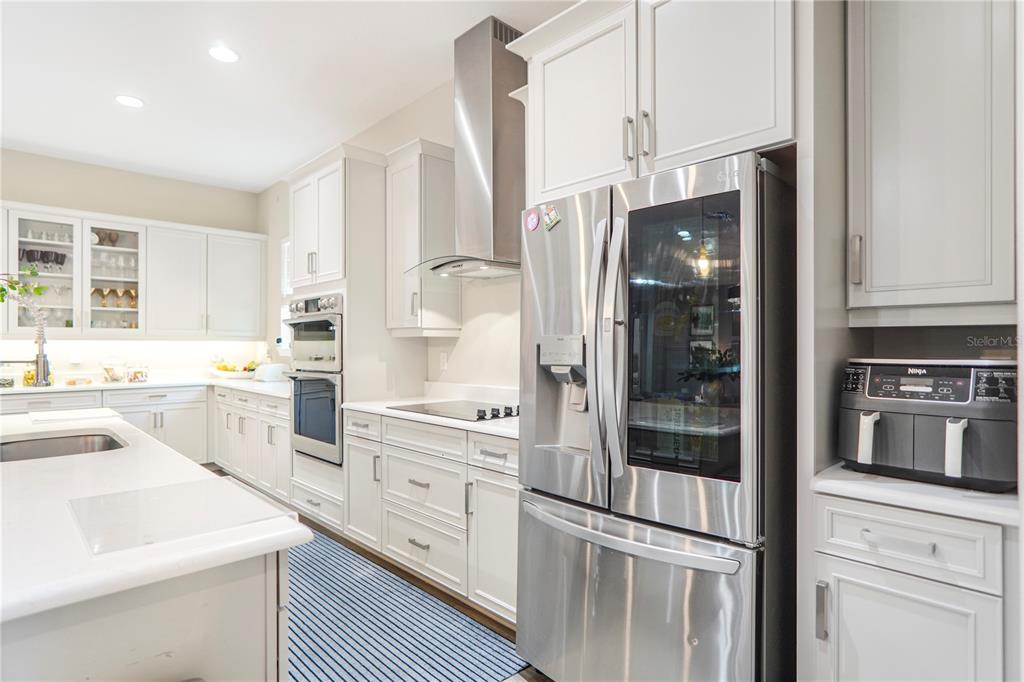 694 Brooks Field Drive Winter Garden, FL 34787 - Photo 34 of 74 a kitchen with white cabinets and white appliances