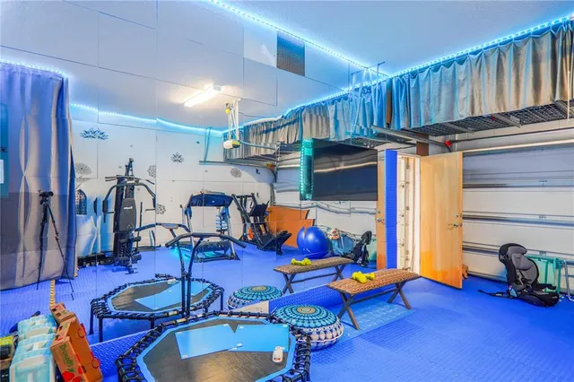 a view of a bedroom with furniture and wooden floor