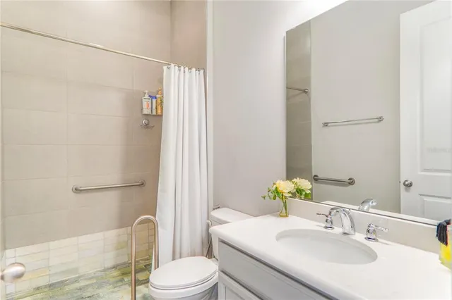 a bedroom with a bed and a night stand