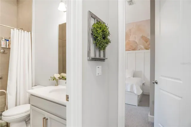 a bed room with a bed and a painting on the wall