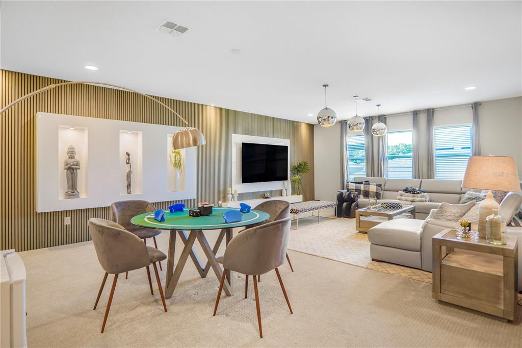 694 Brooks Field Drive Winter Garden, FL 34787 - Photo 46 of 74 a living room with furniture a flat screen tv and a large window