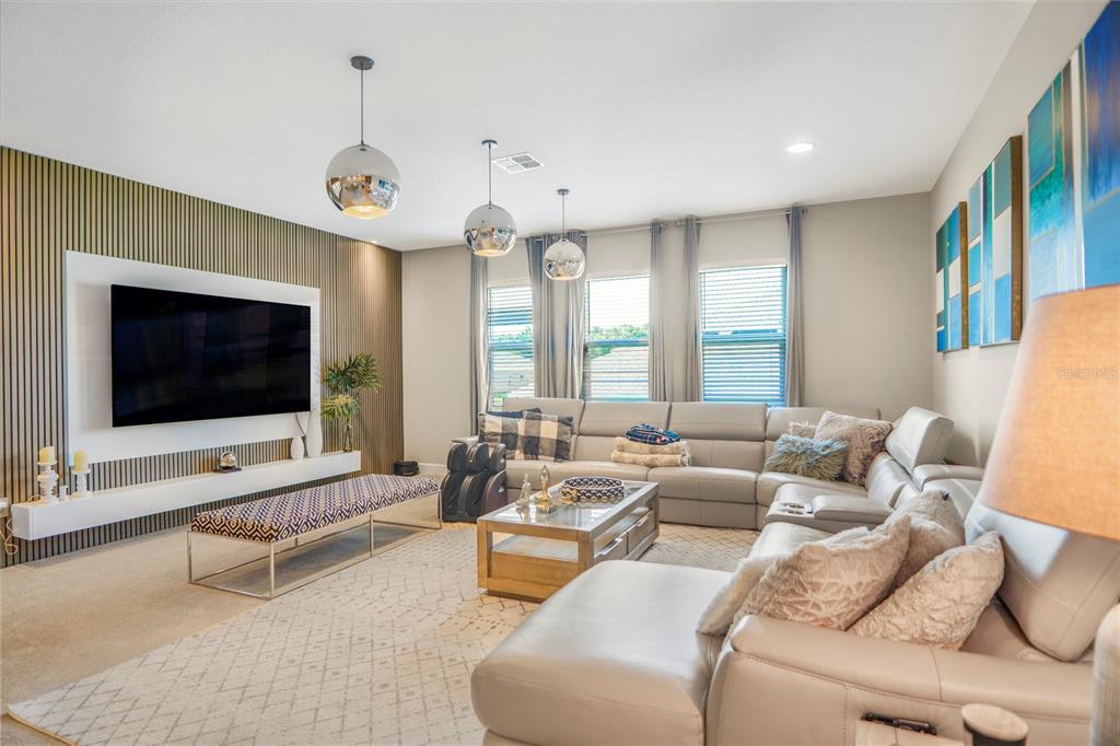 694 Brooks Field Drive Winter Garden, FL 34787 - Photo 47 of 74 a living room with furniture and a flat screen tv