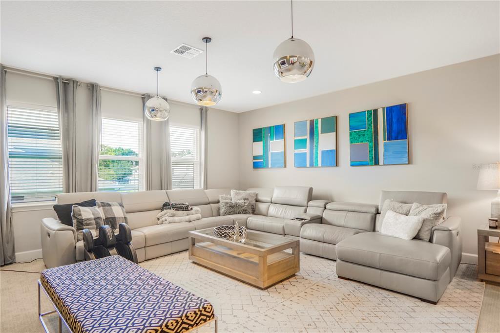 694 Brooks Field Drive Winter Garden, FL 34787 - Photo 50 of 74 a living room with furniture ceiling fan and a rug