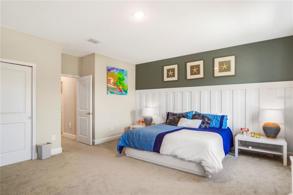694 Brooks Field Drive Winter Garden, FL 34787 - Photo 57 of 74 a bed room with a bed and a painting on the wall