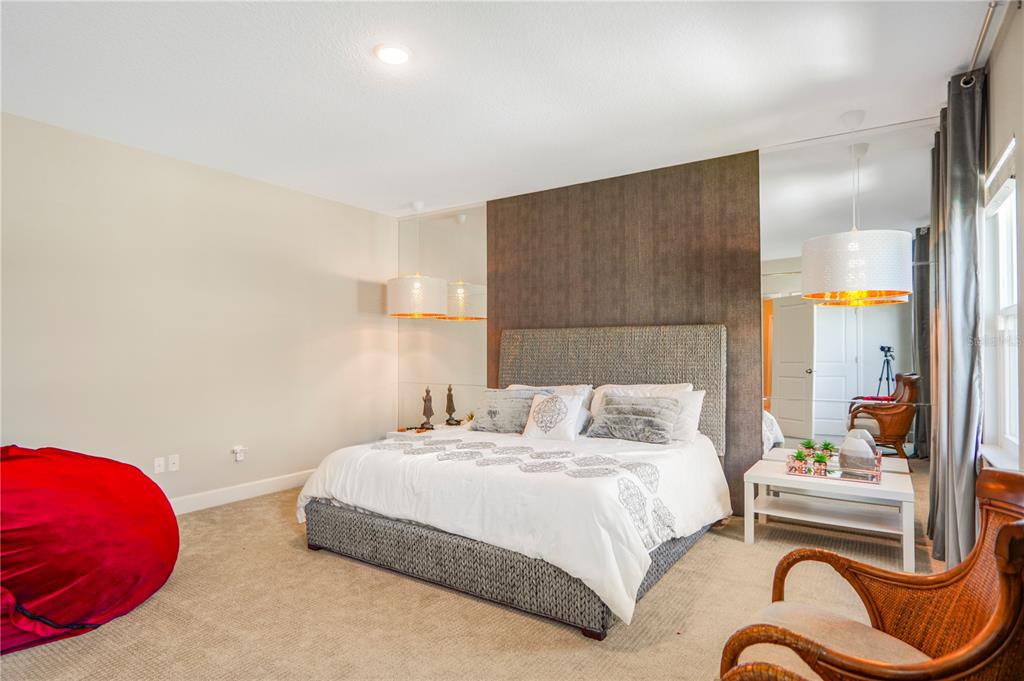 694 Brooks Field Drive Winter Garden, FL 34787 - Photo 61 of 74 a bedroom with a bed and closet with wooden floor