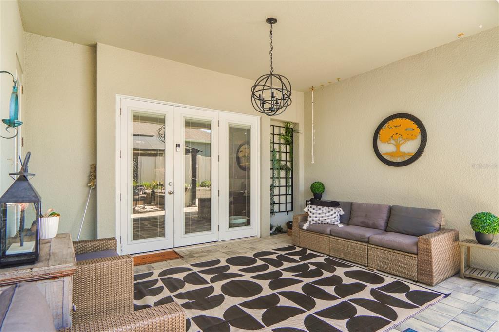 694 Brooks Field Drive Winter Garden, FL 34787 - Photo 64 of 74 a living room with a couch and a chandelier