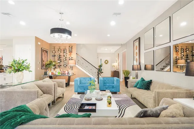 a living room with furniture and kitchen view