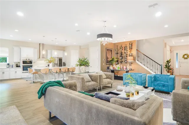 a living room with blue lights with furniture and floor to ceiling window