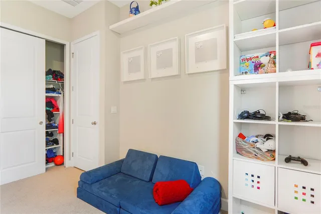 a very nice looking living room with a large window and a dining table